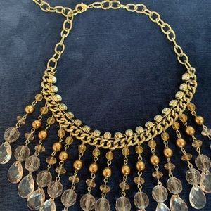 Dressy bib necklace in gold clear and pink color.
